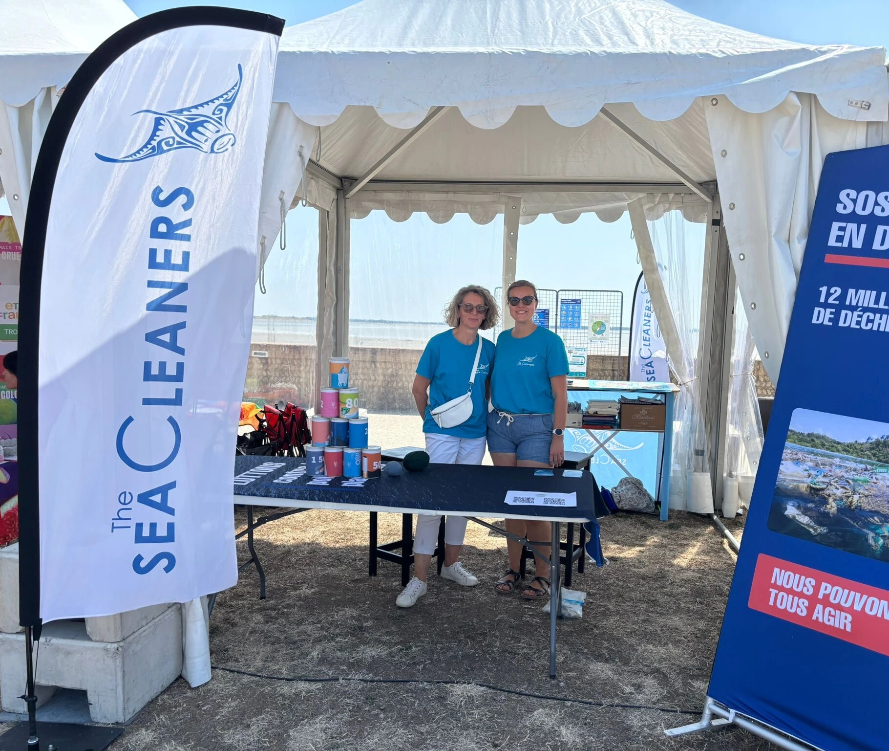 Sea Cleaners booth at outdoor event with banners